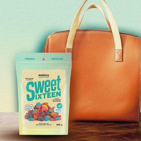 Mondoux Sweet Sixteen Vegan Sour Gummies, 350g, picture of gummy bag beside a purse.