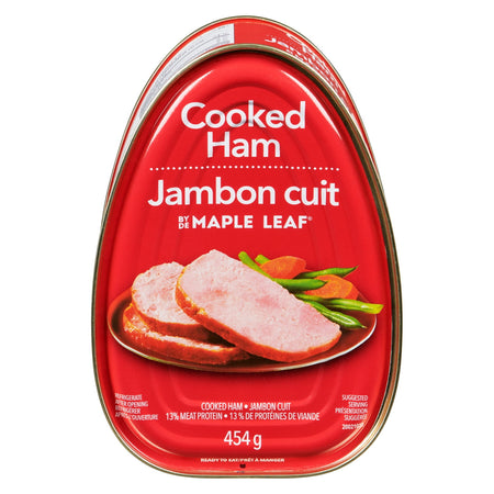 Red packaging of Maple Leaf Cooked Ham with images of ham slices and vegetables on a white background.
