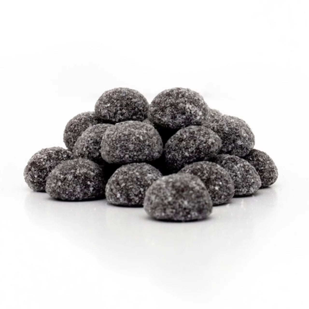 Pile of black raspberry coal gummy candies on a white background