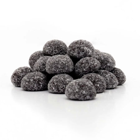 Pile of black raspberry coal gummy candies on a white background