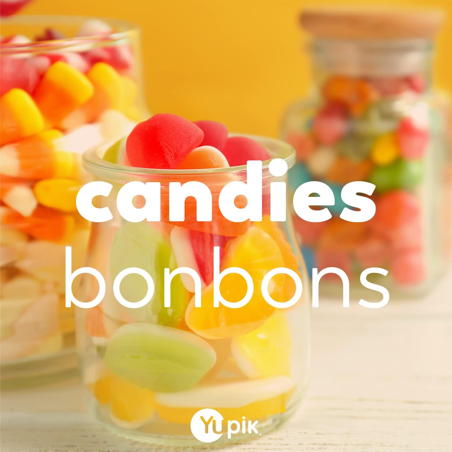 Three jars of colorful candies with the text 'candies bonbons' and 'Yipik' logo.
