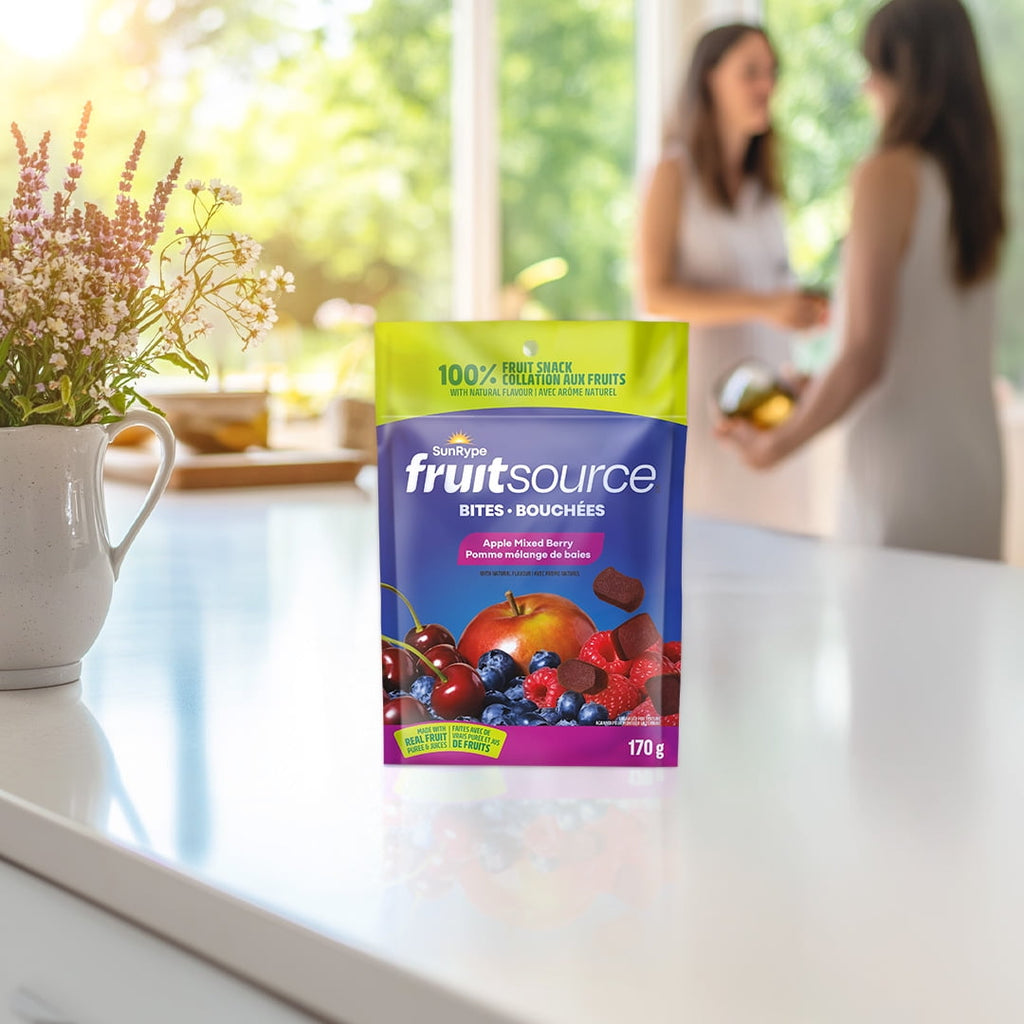 FruitSource snack package on a kitchen counter with blurred people in the background