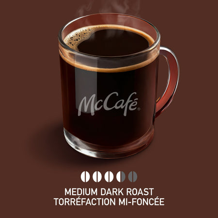 Glass mug of McCafé coffee on a brown background