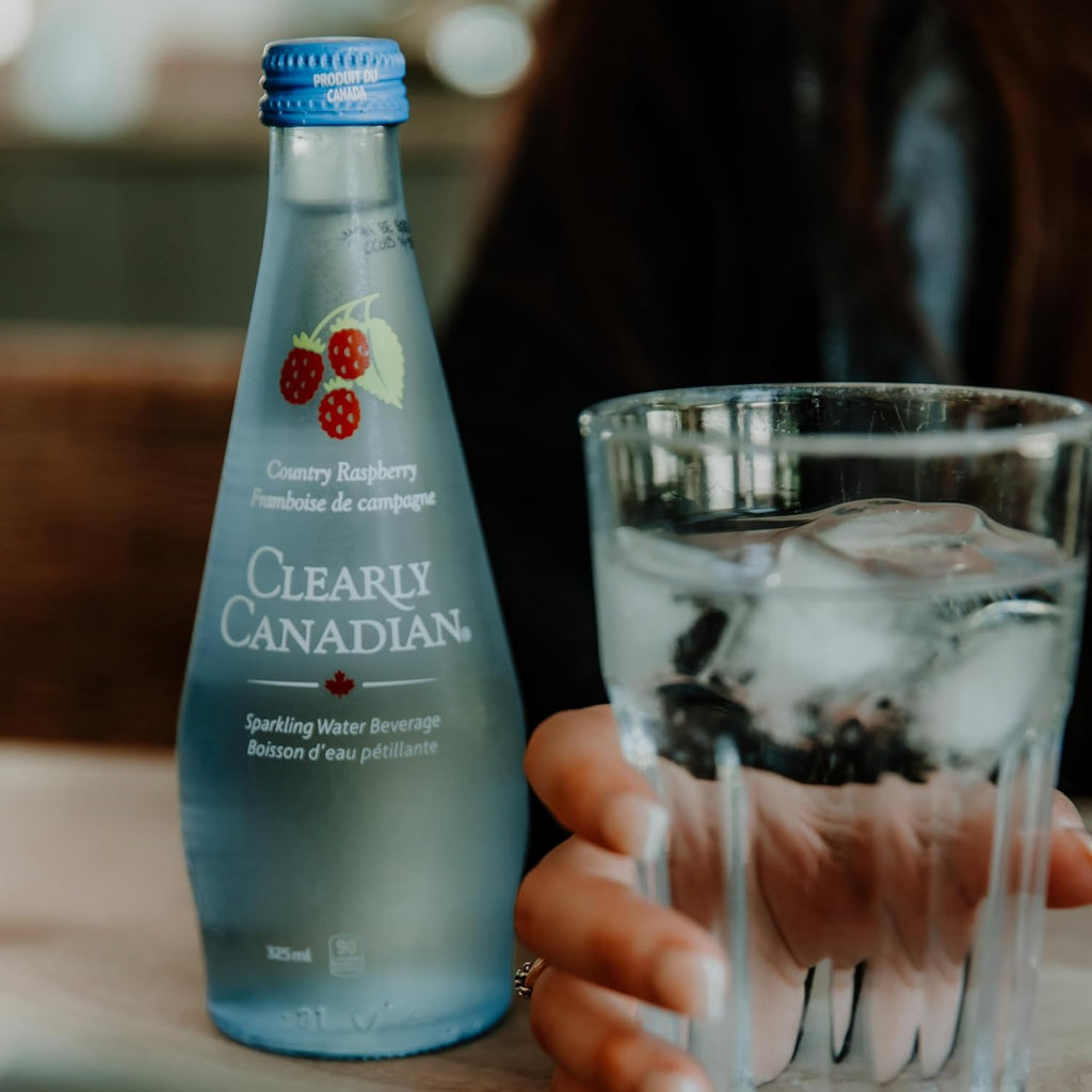 Clearly Canadian Sparkling Water Beverage, Country Raspberry, 325ml/11 Fl oz., Bottle, bottle on the table.