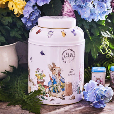 New English Teas Beatrix Potter Peter Rabbit Tea Caddy - 240 Tea Bags - Front of tea canister with Peter Rabbit design surrounded by flowers and leaves