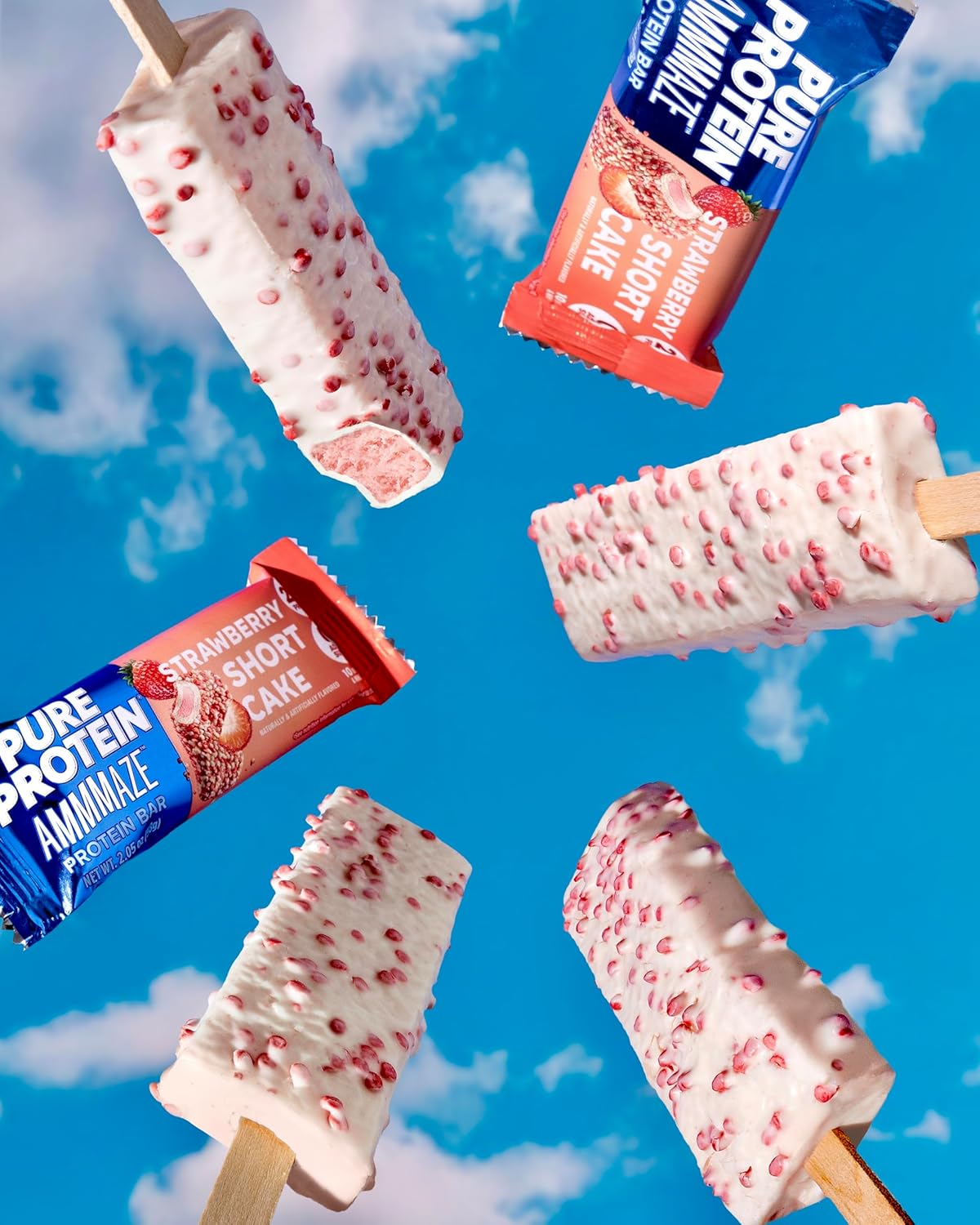 Popsicles with strawberry shortcake flavor and Pure Protein Ammazze bars against a blue sky background.