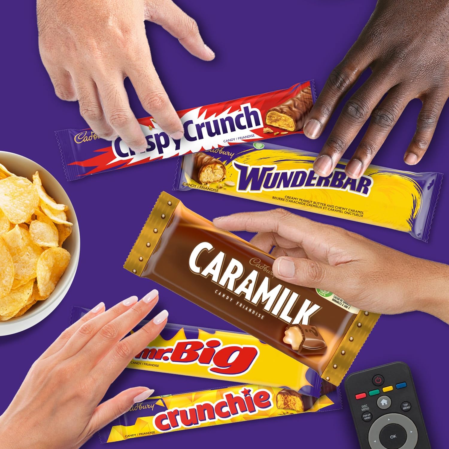 Cadbury chocolate bars with hands reaching towards them on a purple background