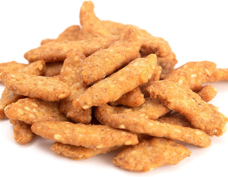 Pile of Yupik salted sesame sticks on a white background