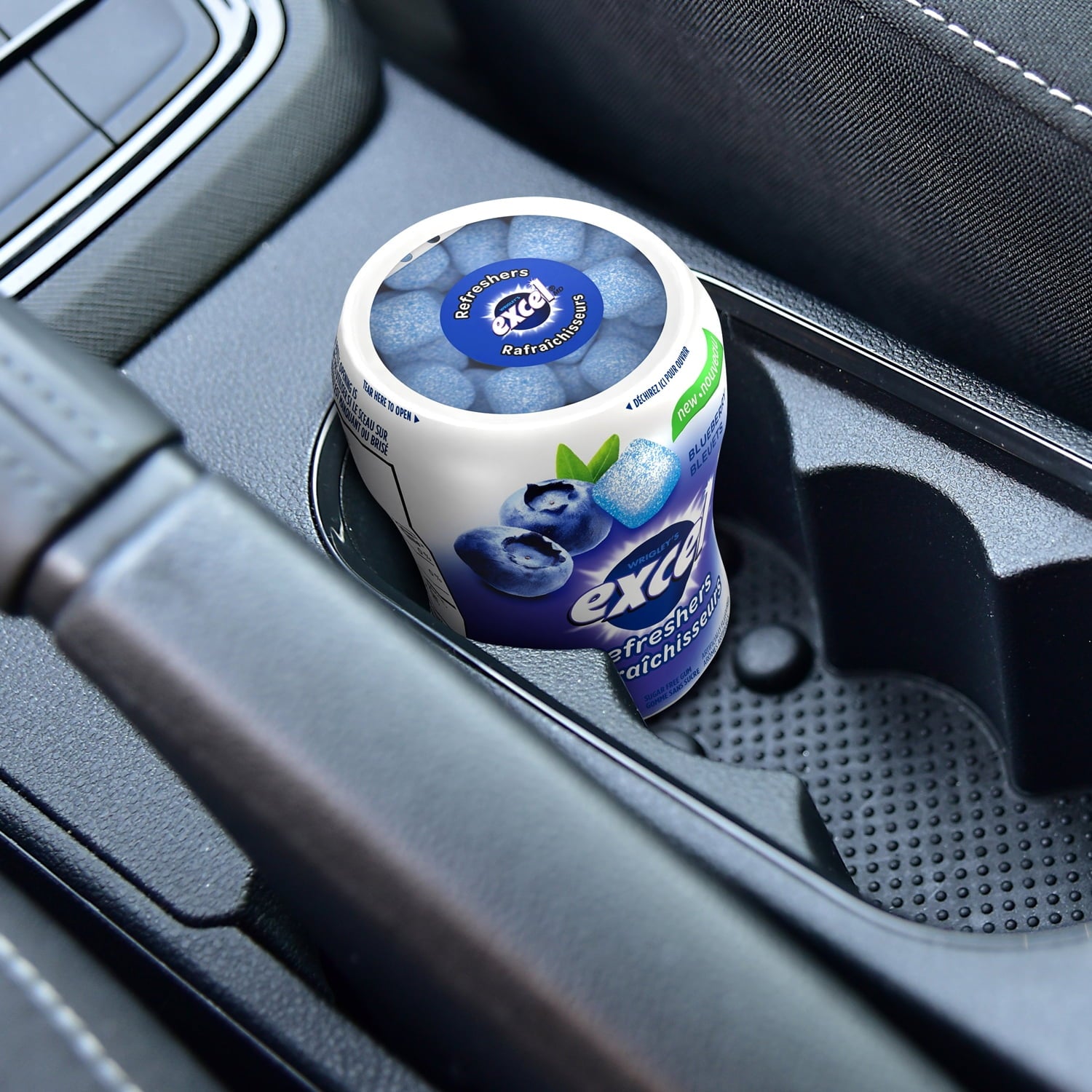 Excel Sugar-Free Gum, Refresher Blueberry, 6 ct. Package, one bottle in a cup holder in a car