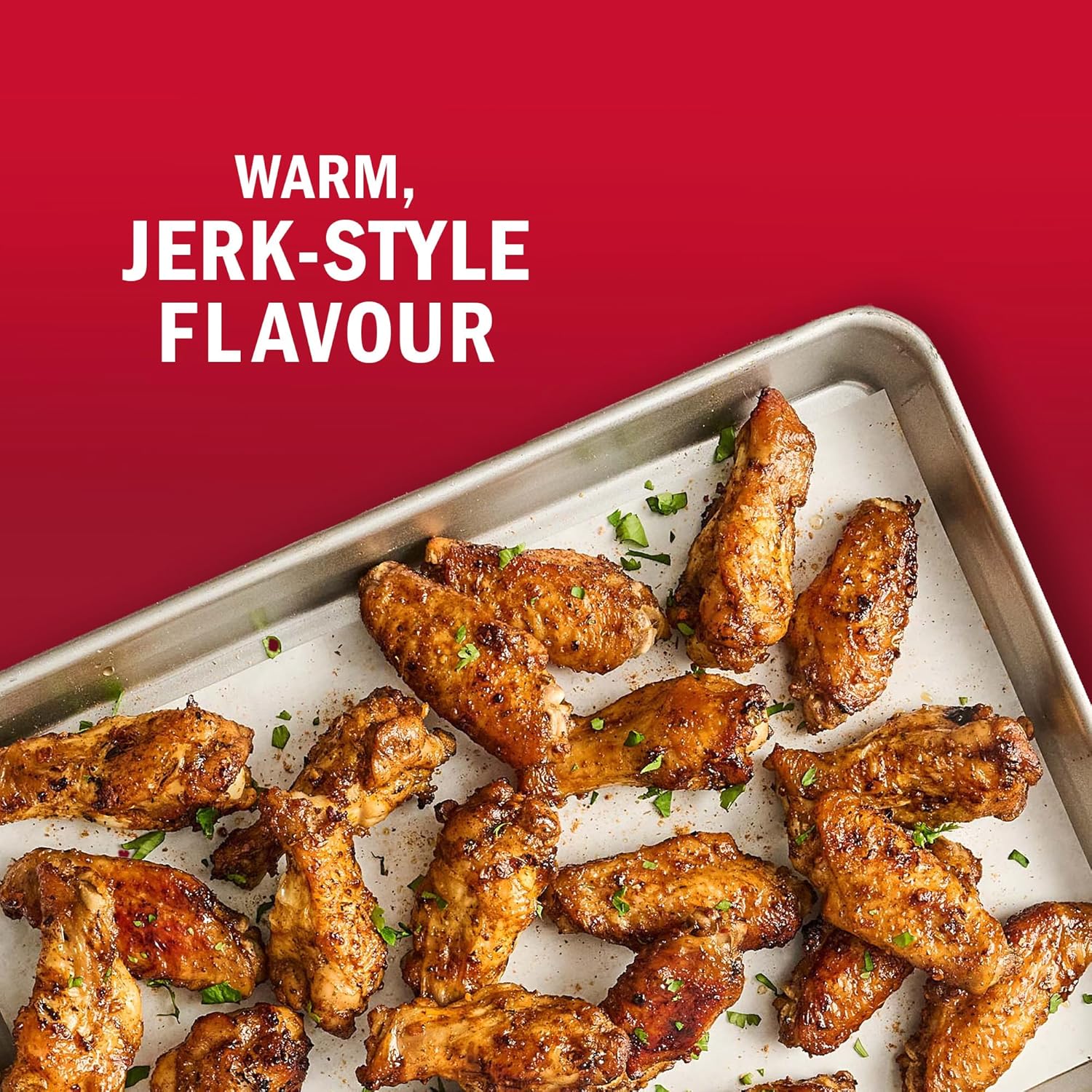 Baked chicken wings on a baking tray with 'Warm, Jerk-Style Flavour' text on a red background