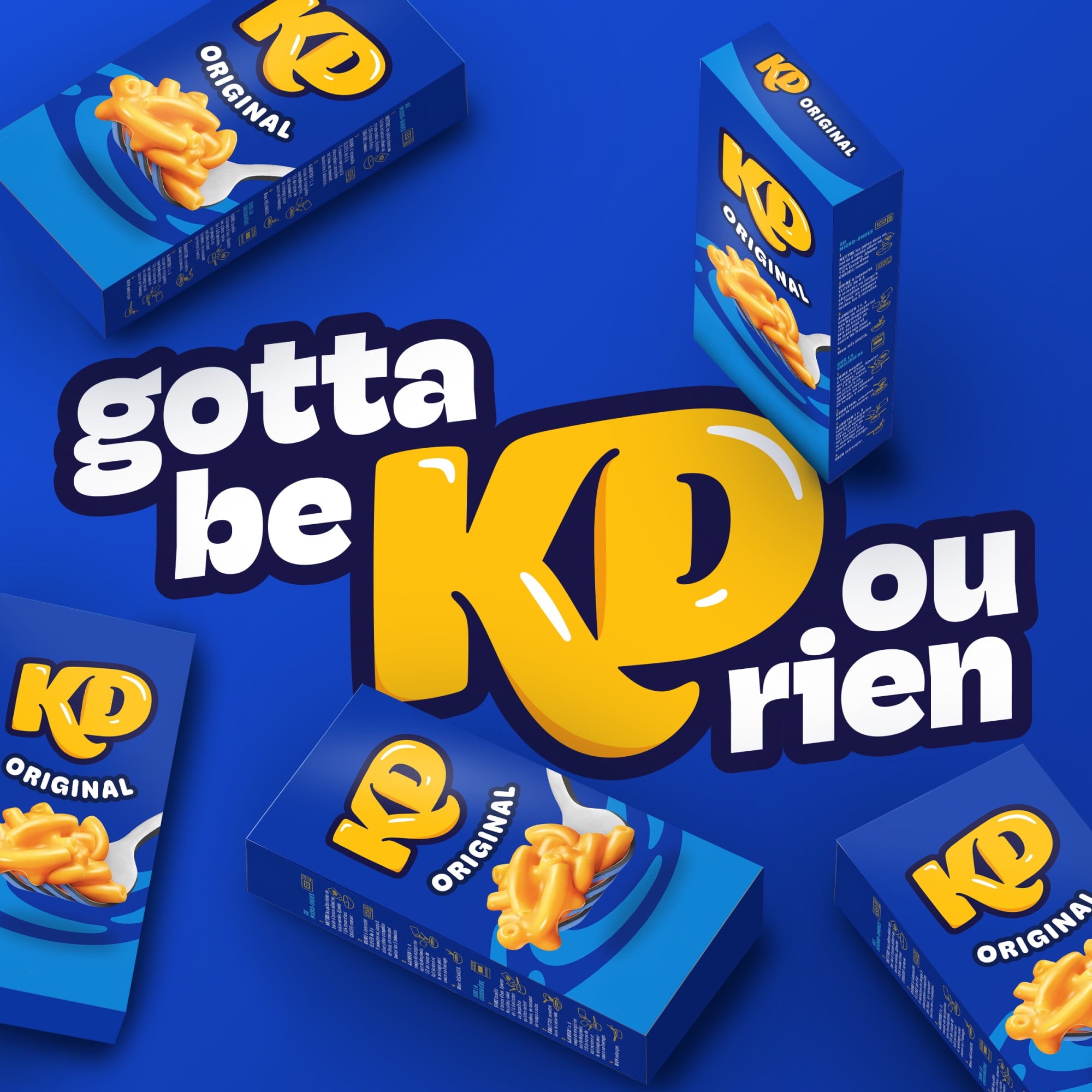 Blue boxes of KD Original with yellow macaroni and cheese illustration on a blue background, featuring text 'gotta be KD ou rien'.