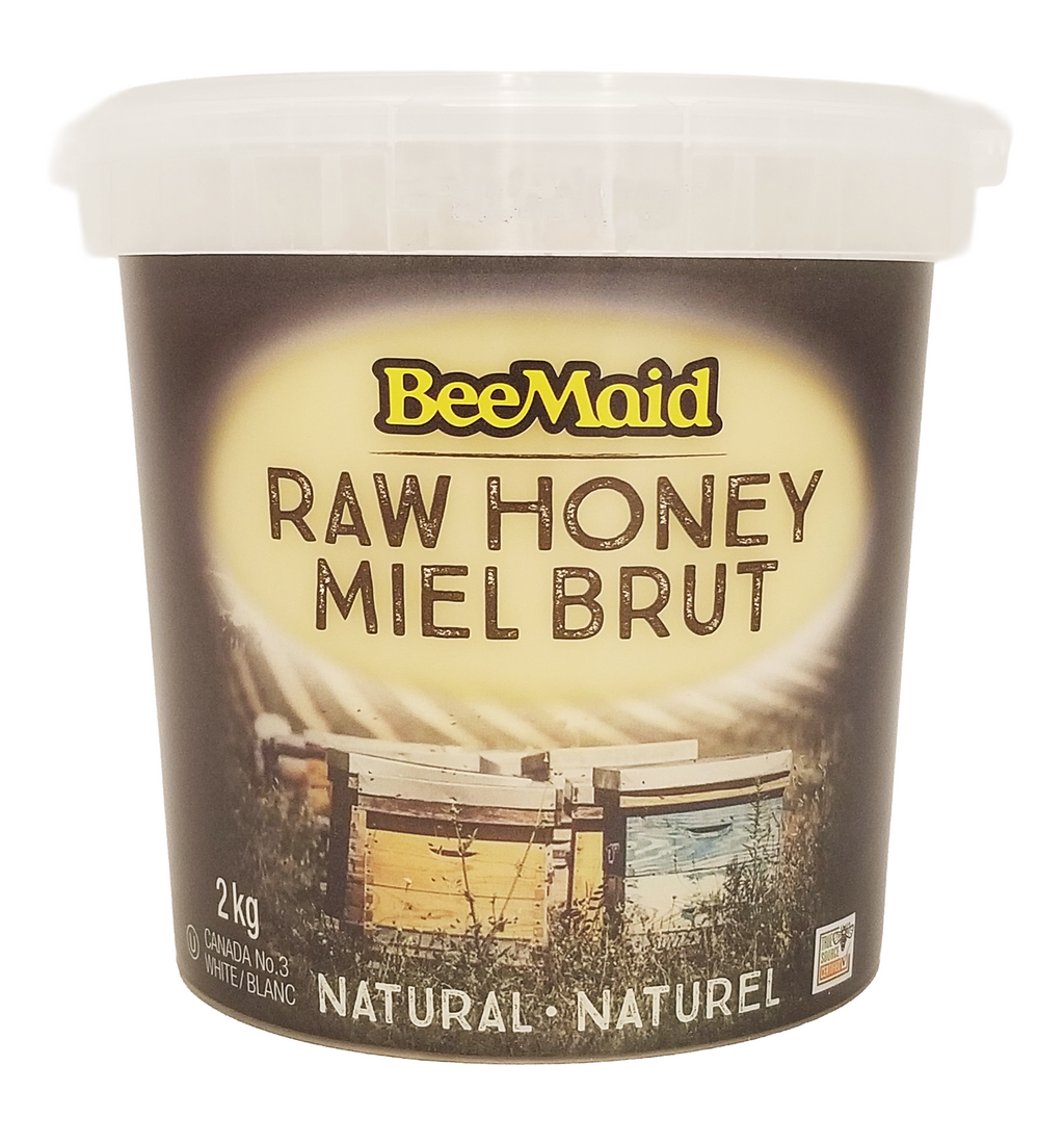 Container of BeeMaid raw honey 2kg with a bee hive image on the label.