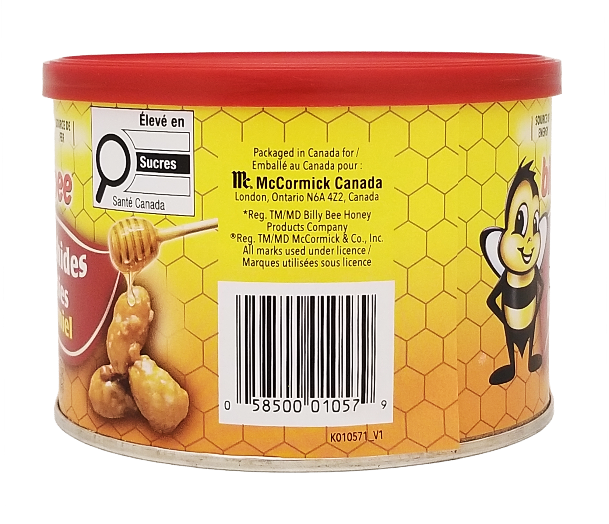 Canister of McCormick Billy Bee Honey with a red lid and yellow label featuring honeycomb design.