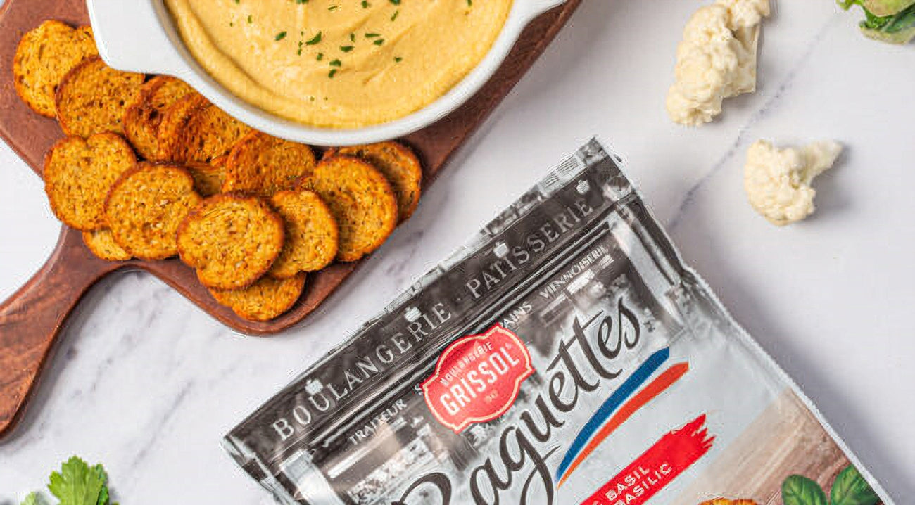 Boulangerie Grissol Baguettes, Tomato & Basil, 120g, baguette slices arranged on a cutting board with a bowl of soup.