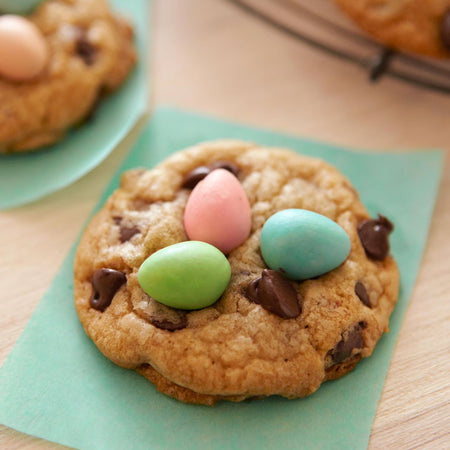 Cookie with colorful candy eggs on a green napkin