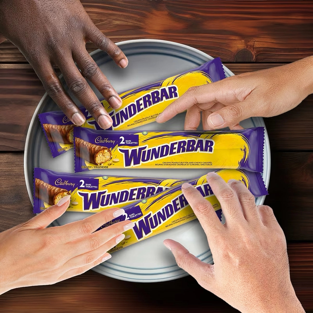 Wunderbar chocolate bars on a tray with hands reaching for them