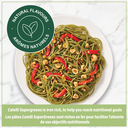 Plate of Catelli SuperGreens pasta with red peppers and nuts on a white plate, with a label indicating natural flavors.