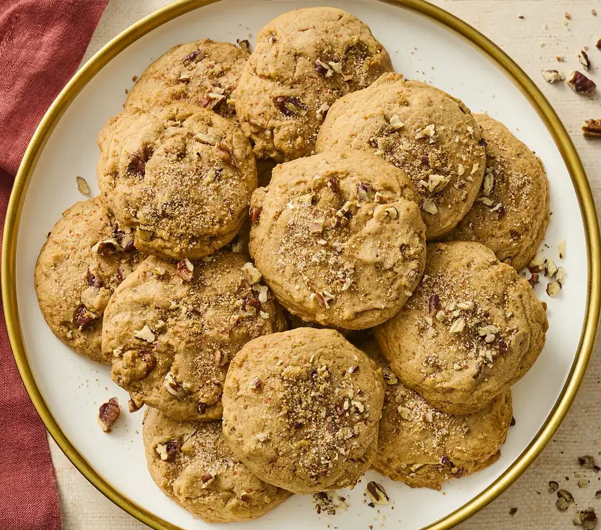 Plate of cookies with nuts on a white plate with gold rim