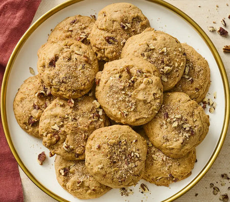 Plate of cookies with nuts on a white plate with gold rim
