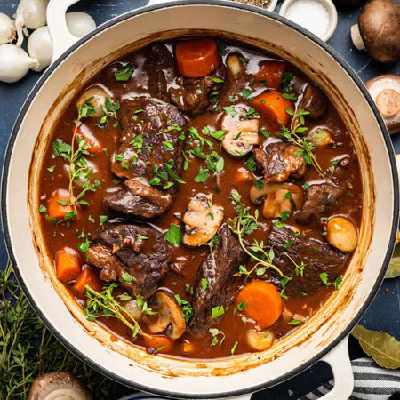 Hearty beef stew made with Compliments Beef Bouillon Concentrate — braised beef, carrots, mushrooms, and herbs in rich brown broth