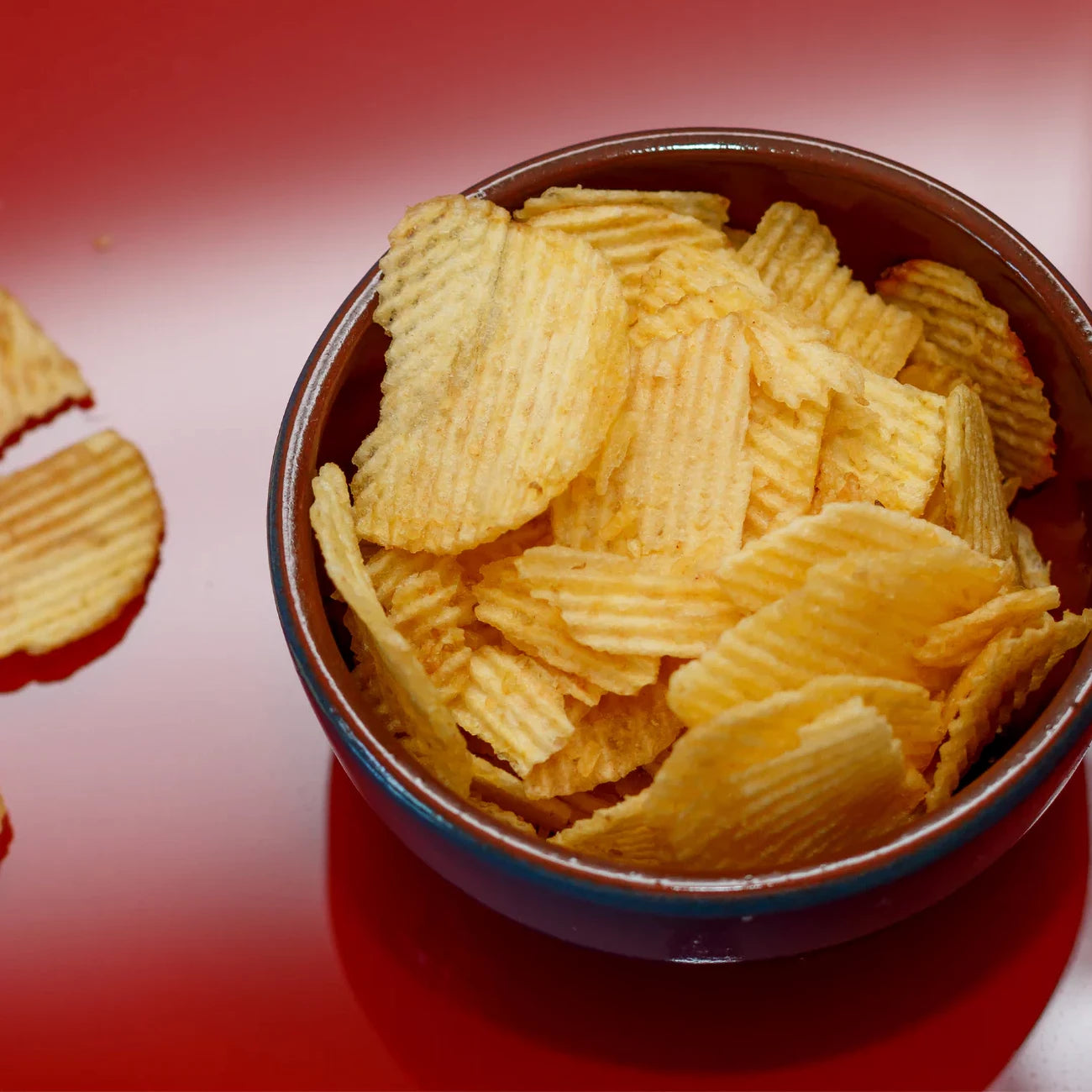 Compliments Extraaa All Dressed Flavor Ridged Potato Chips in a bowl.