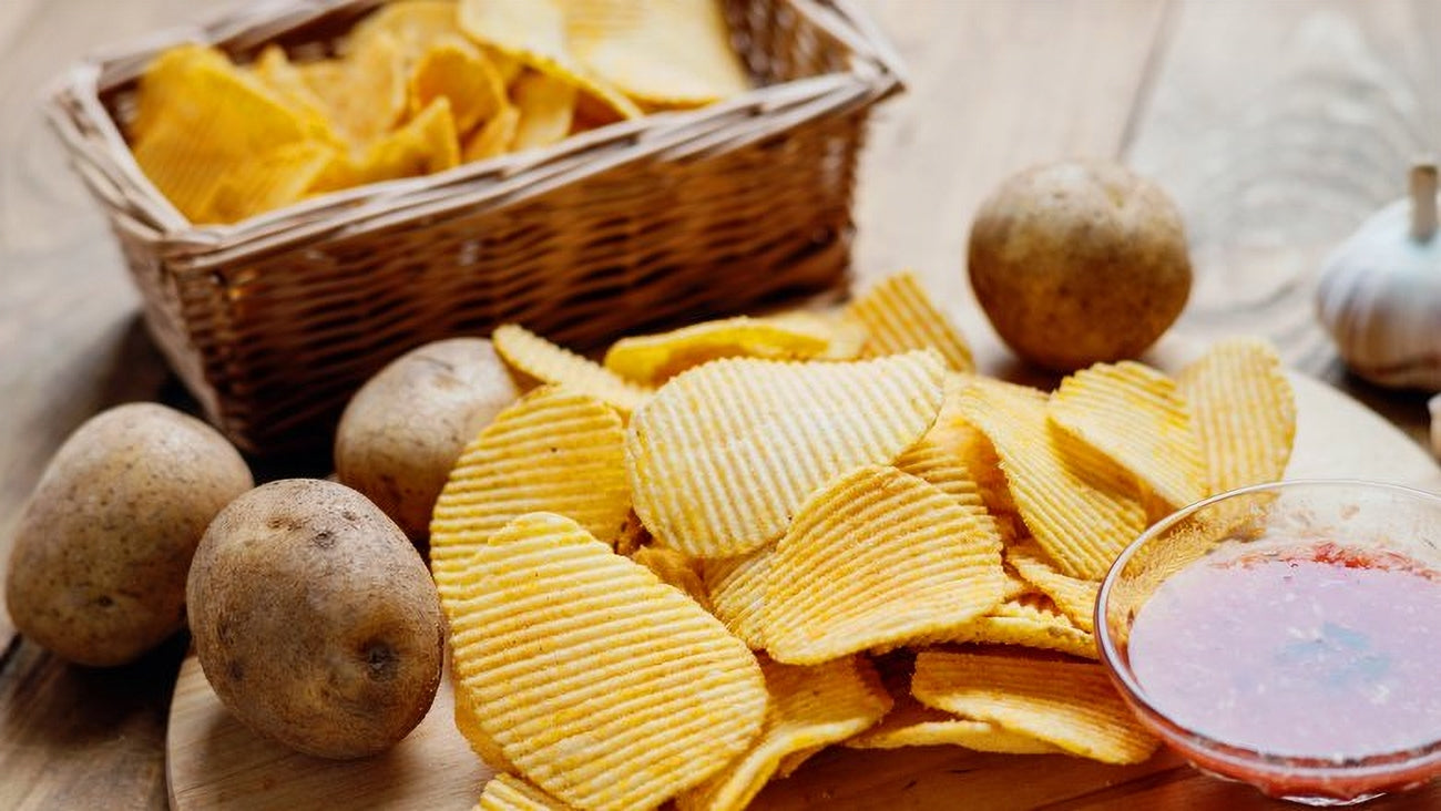 Compliments Extraaa All Dressed Flavor Ridged Potato Chips on a board.