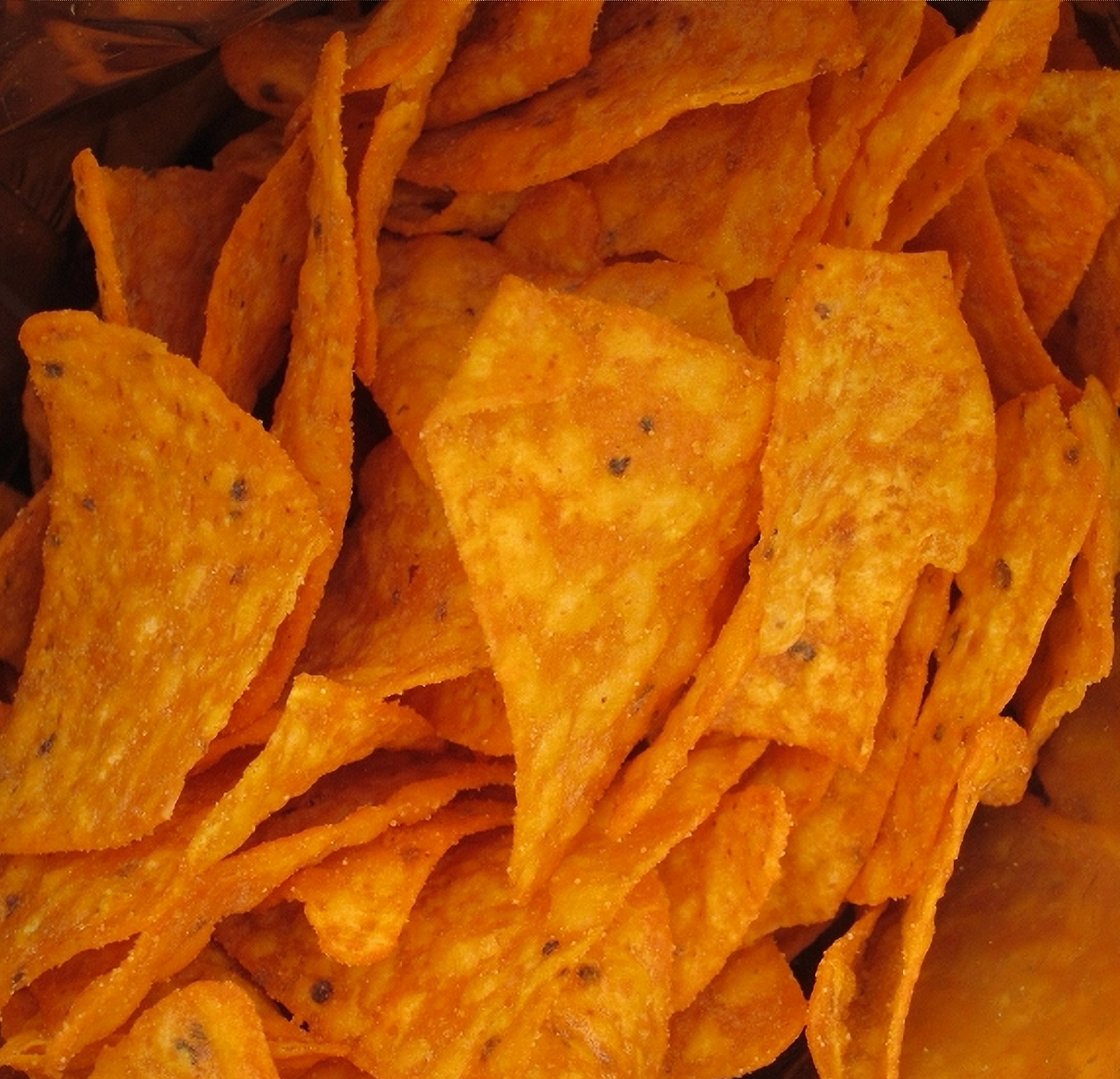 Doritos Sweet Chili Heat chips spilling out of open 45g bag