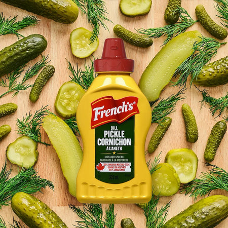 French's Dill Pickle Mustard 325ml bottle surrounded by fresh dill pickles