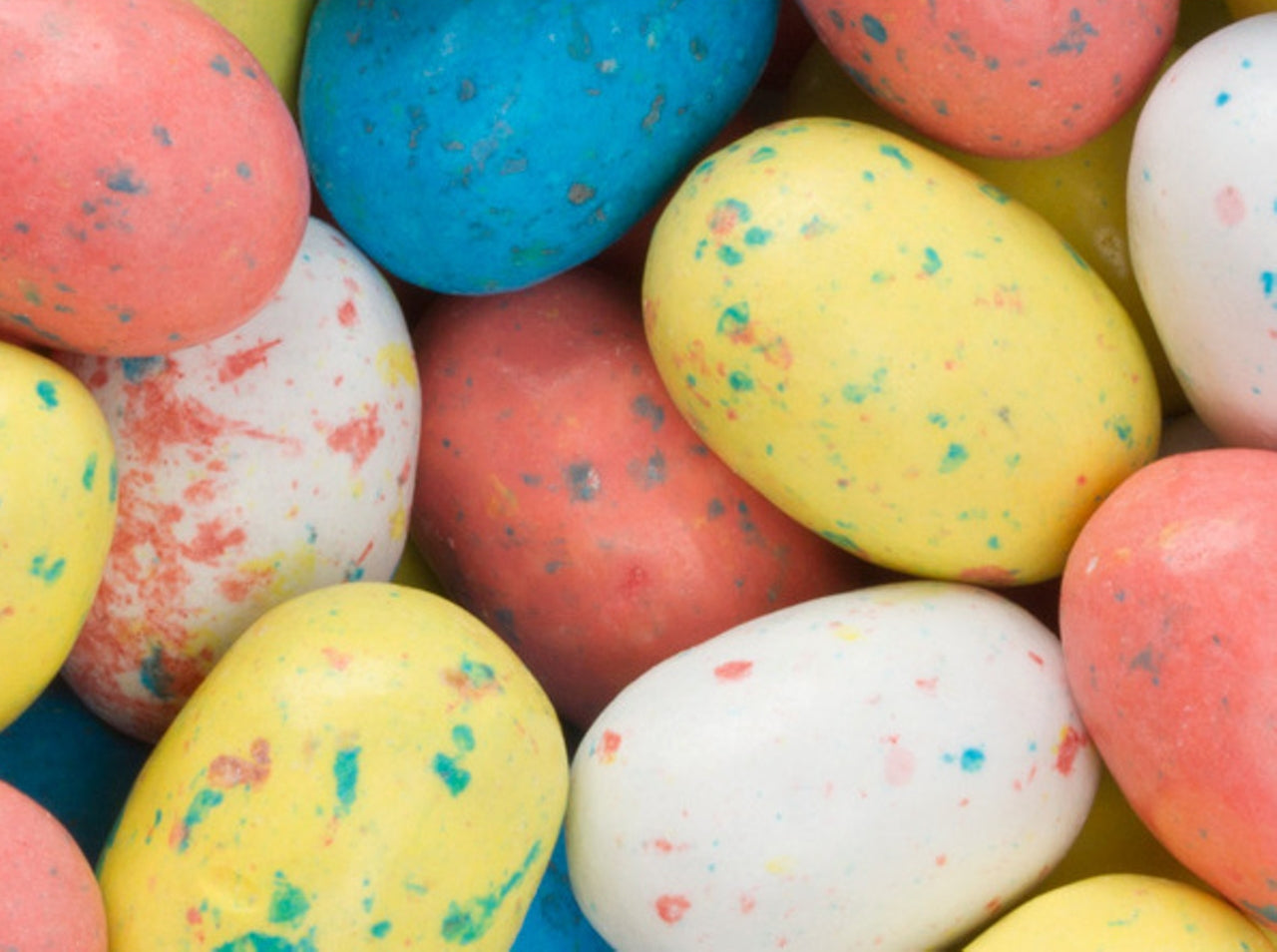 Colorful speckled Easter eggs on a blue background
