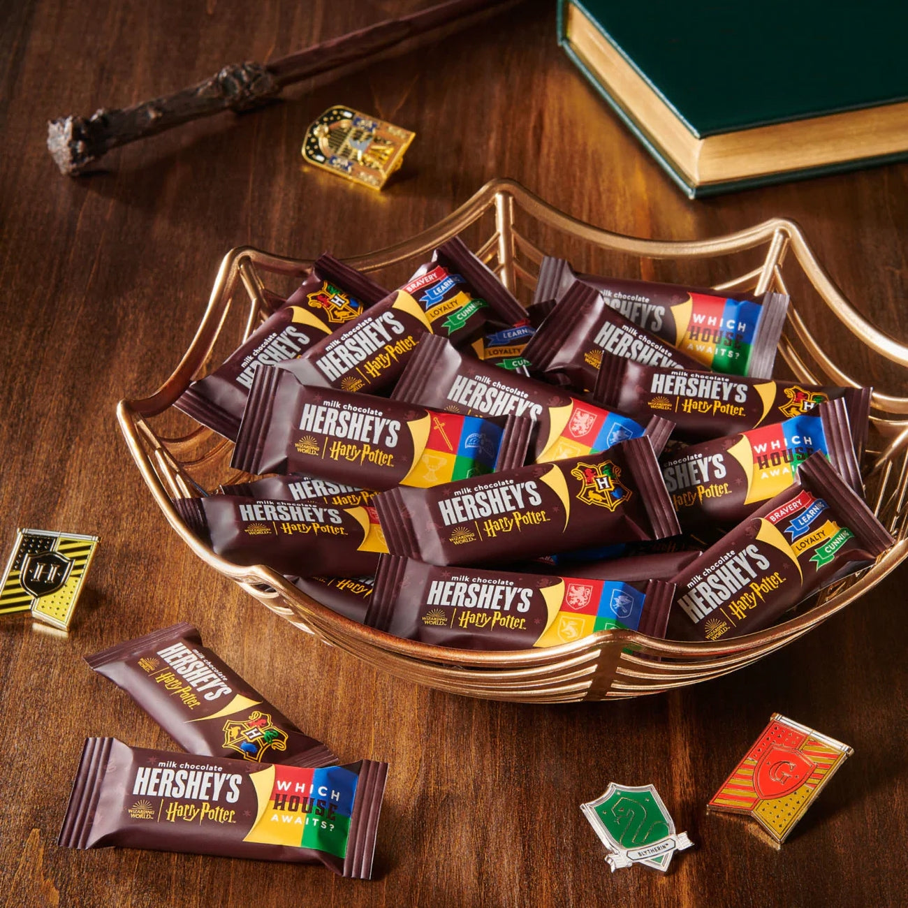 Hershey's Harry Potter chocolate bars in a decorative bowl on a wooden surface.