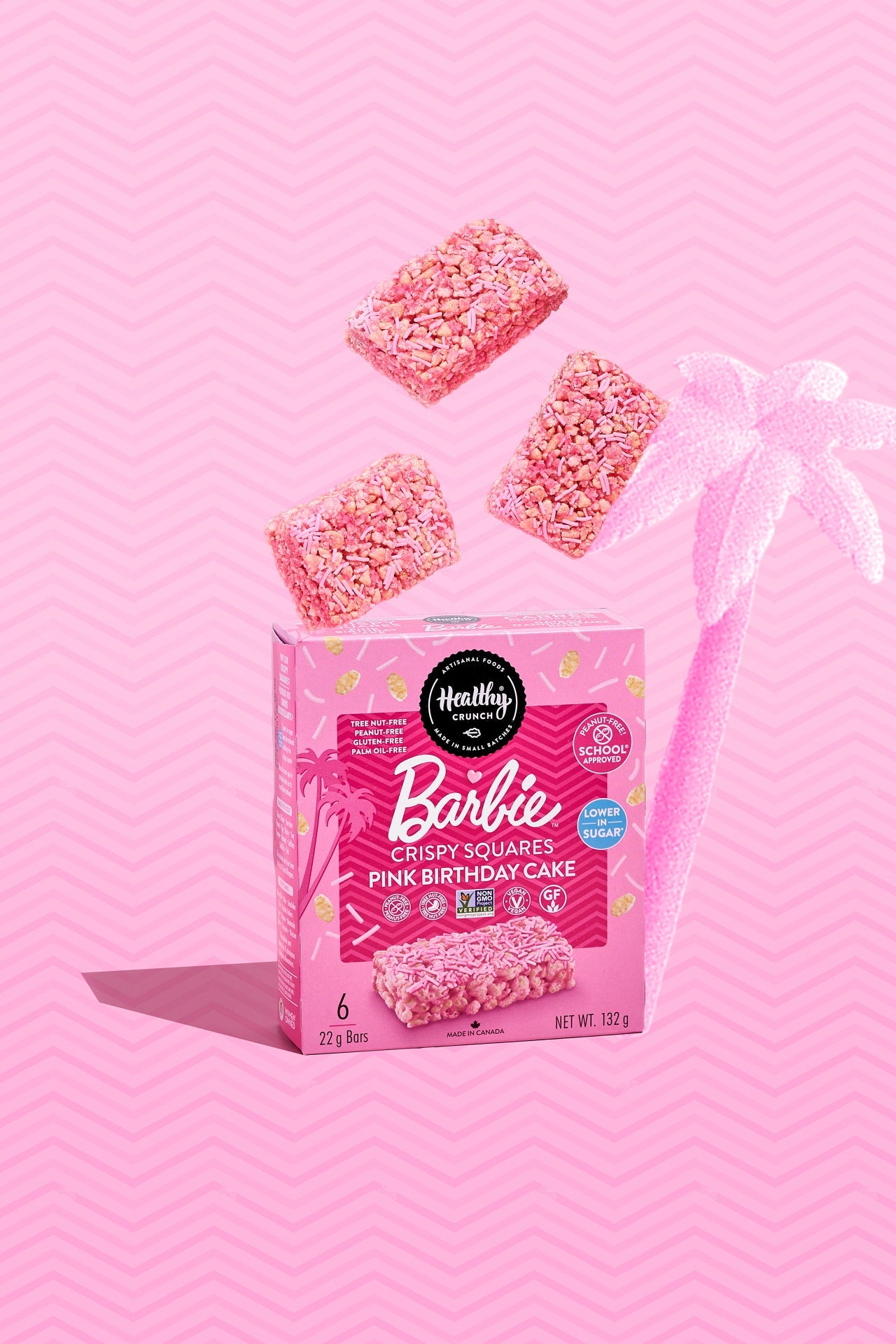 Box of Barbie-themed pink birthday cake crispy squares on a pink background