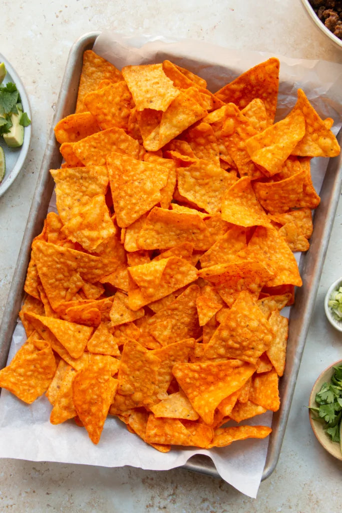 Doritos Late Night Sizzlin' Cheese Burger Tortilla Chips, 69g/2.4 oz., picture of tortilla chips on a plater.