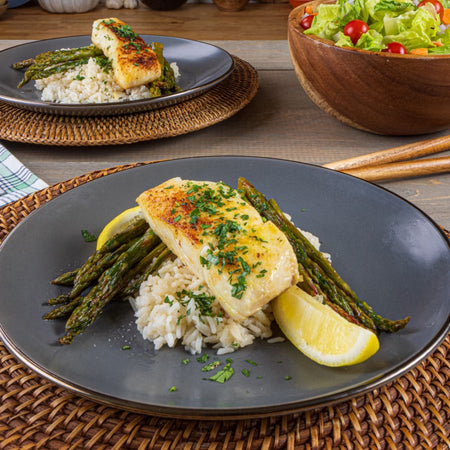 Seasoned white fish fillet with roasted asparagus and rice plated with Kinder's Caramelized Onion Butter Seasoning