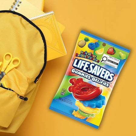 Lifesavers gummies package 180g on a yellow background with a yellow bag and scissors.
