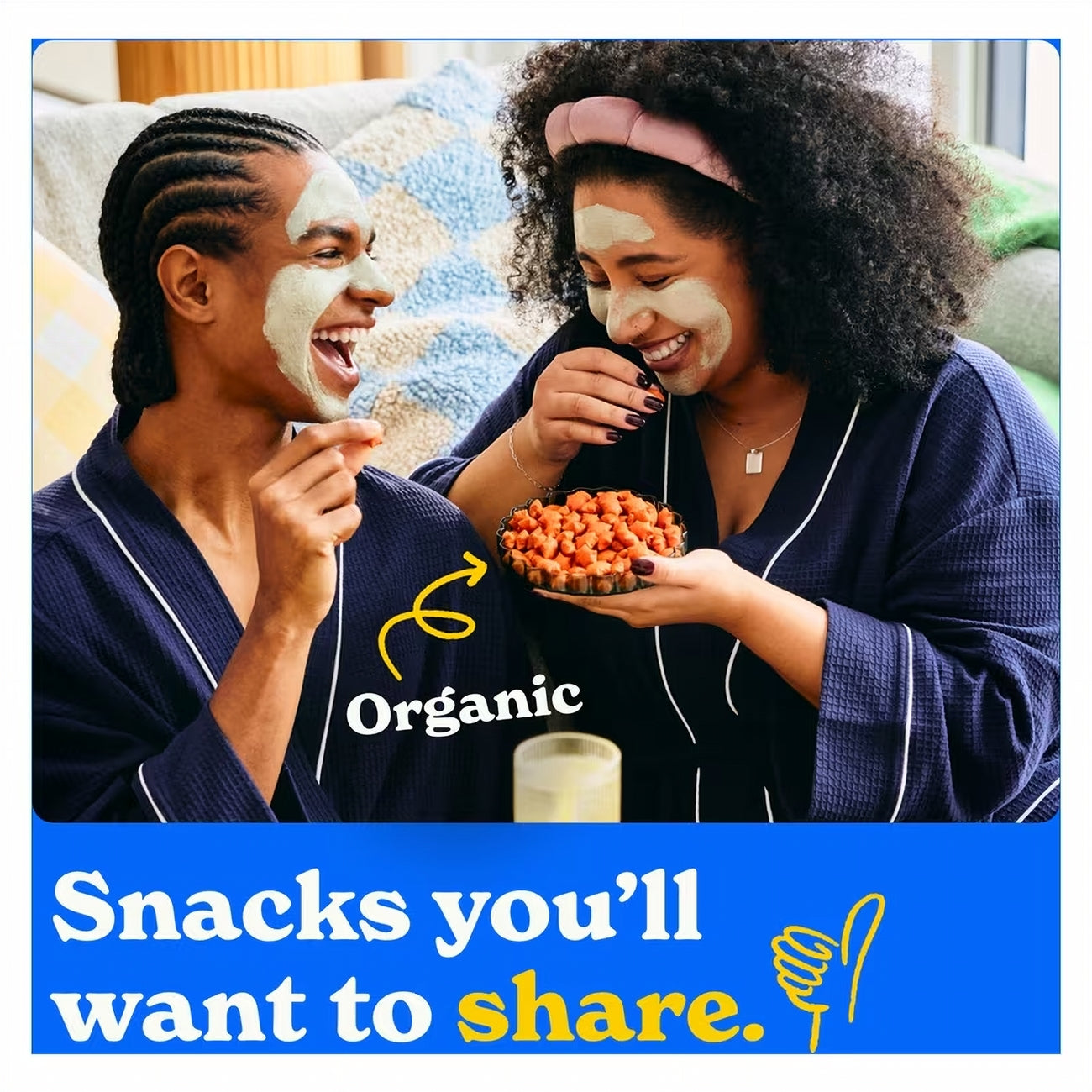 Two people in pajamas with face masks, eating snacks with 'Organic' branding.