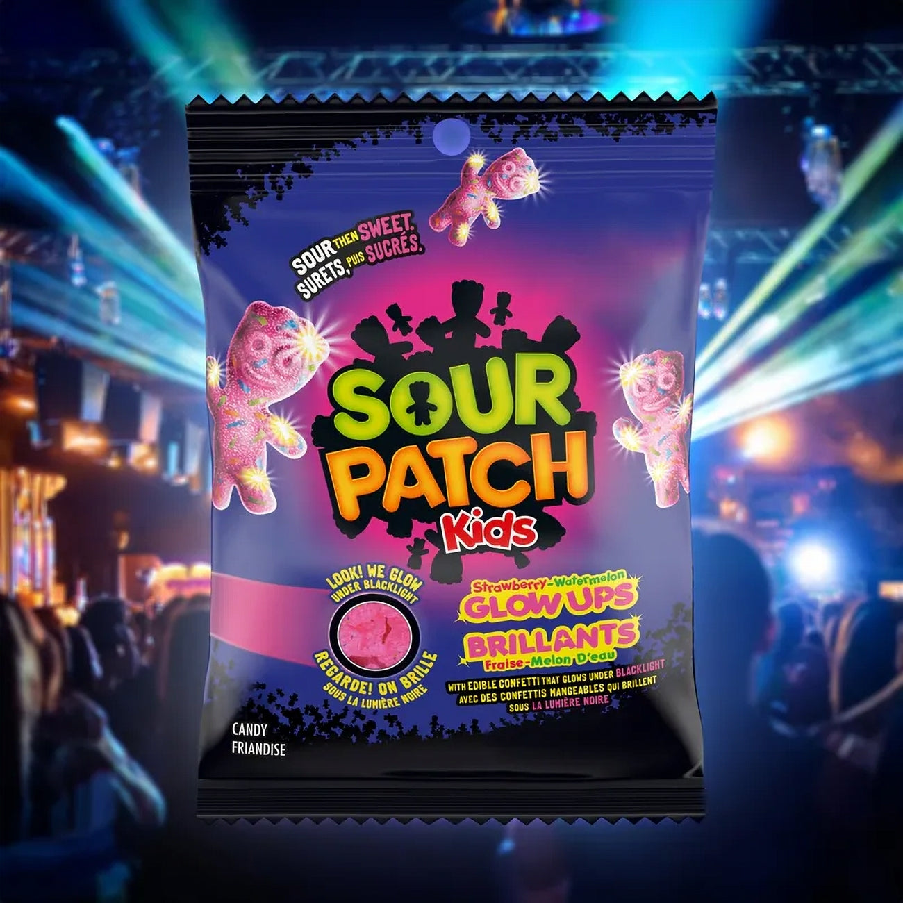 Sour Patch Kids Strawberry Watermelon Glow-Ups Gummies in a colorful package on a colorful background with lights