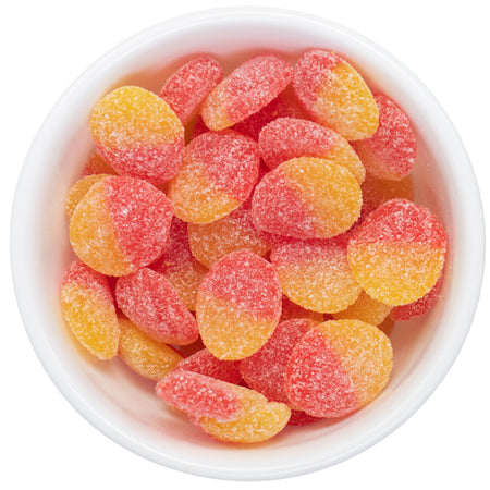White bowl filled with Allan Peach Slices gummy candies on a white background