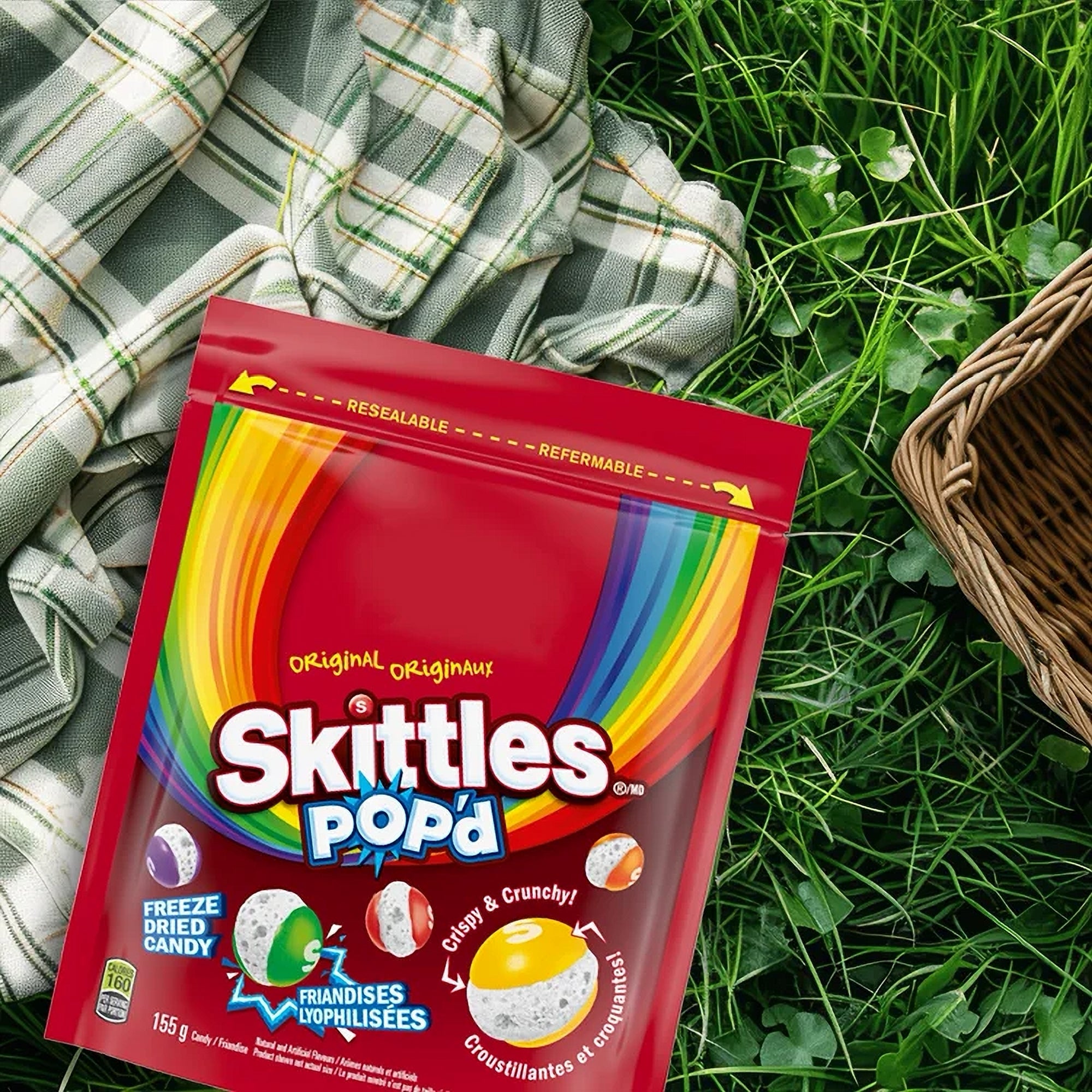 Skittles Popd packaging on grass with plaid blanket
