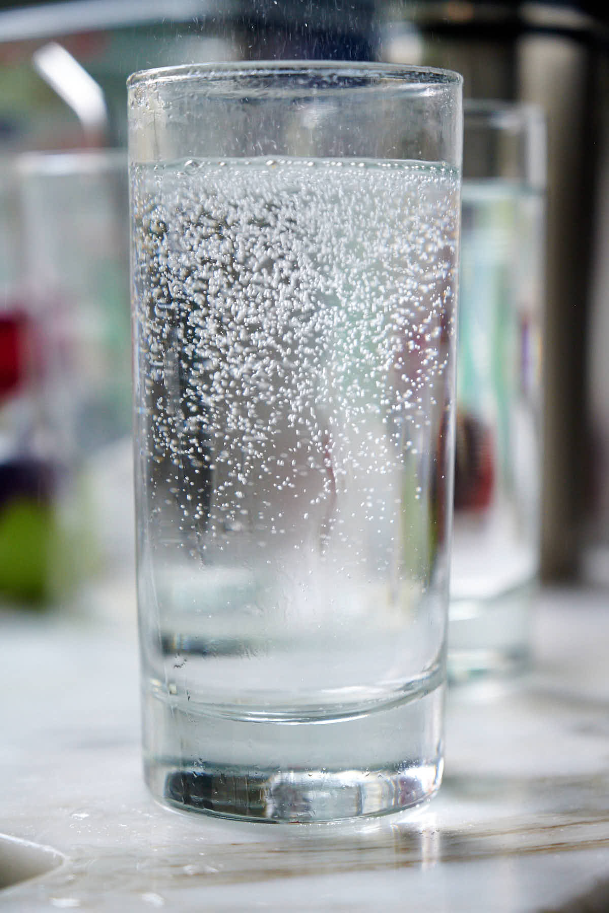 Clear glass with bubbling liquid on a blurred background