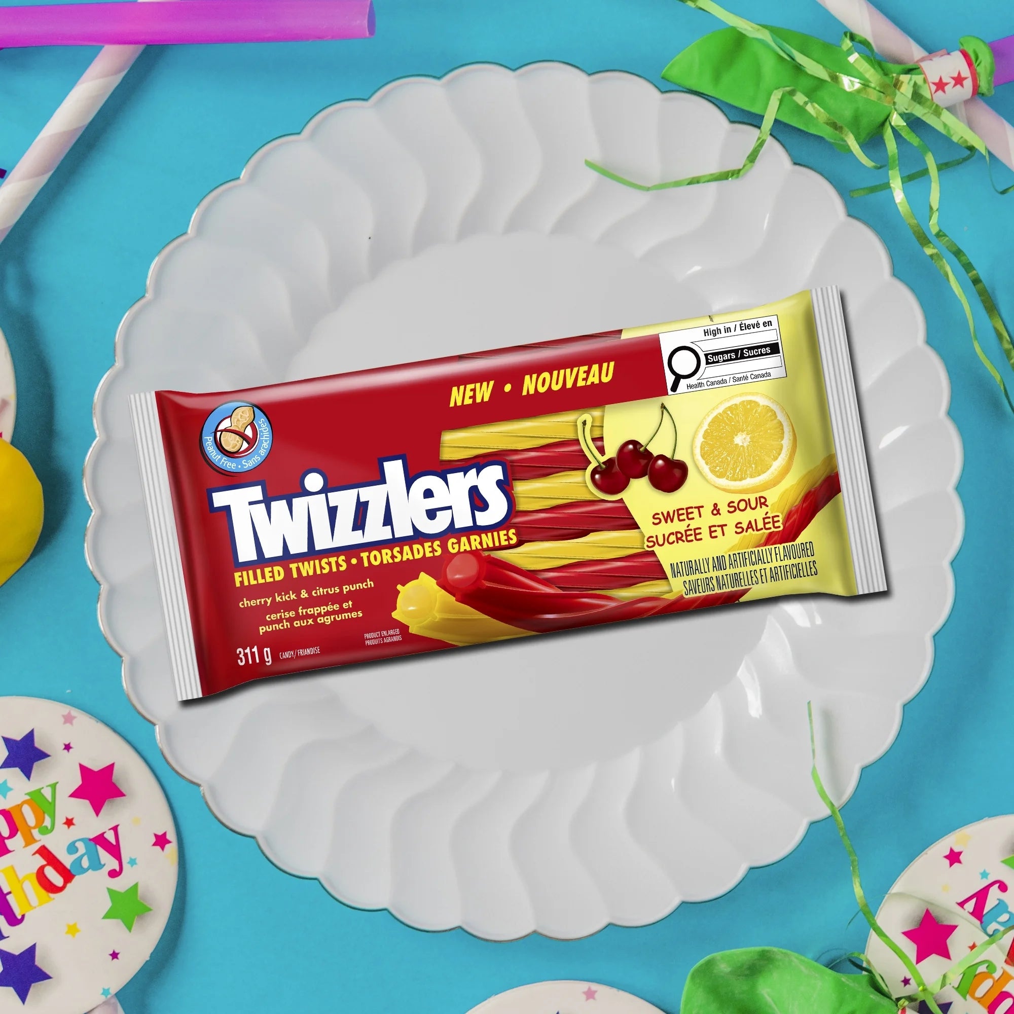 Twizzlers Sweet & Sour candy package on a white plate with a blue background