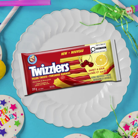Twizzlers Sweet & Sour candy package on a white plate with a blue background