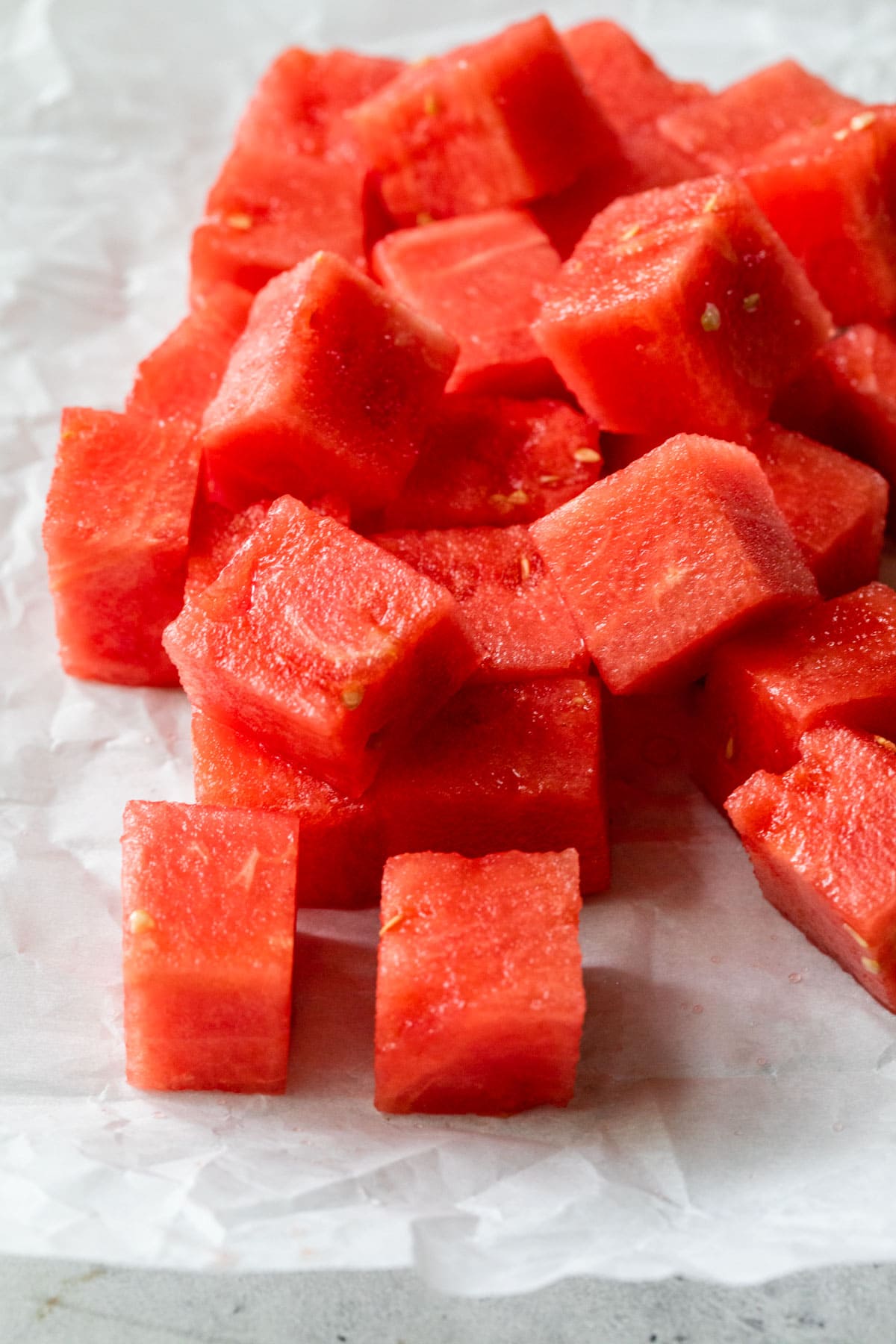 Cubed watermelon on a white paper background