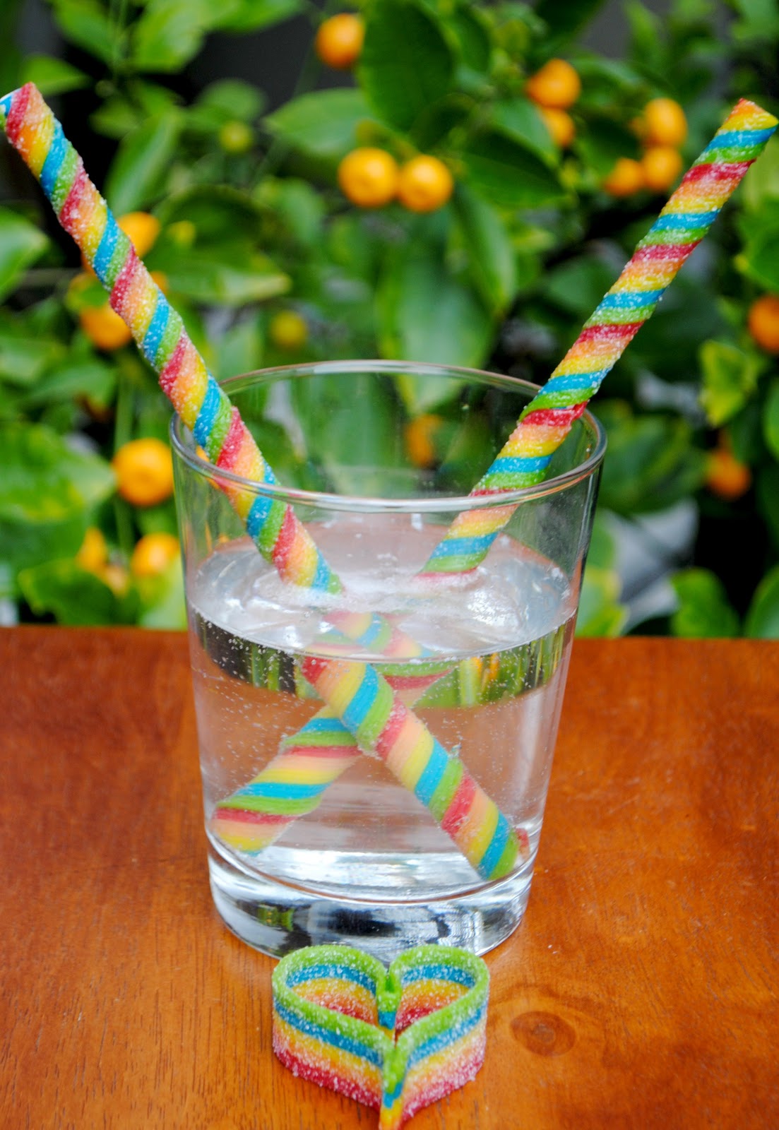 Huer Sour Rainbow Creme Whips Gummy Candy, 70g/2.5 oz., sour rainbow whips in a glass of carbonated water.