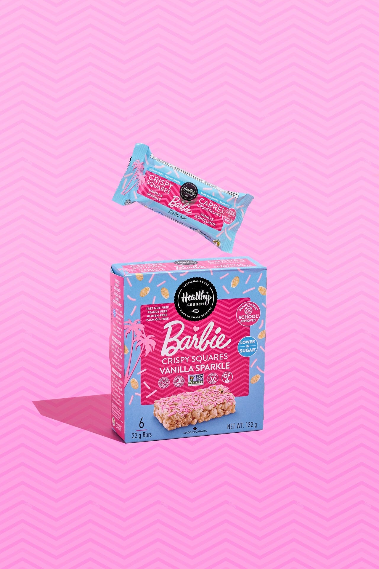 Box and single serving package of Barbie Crunchy Squares on a pink background