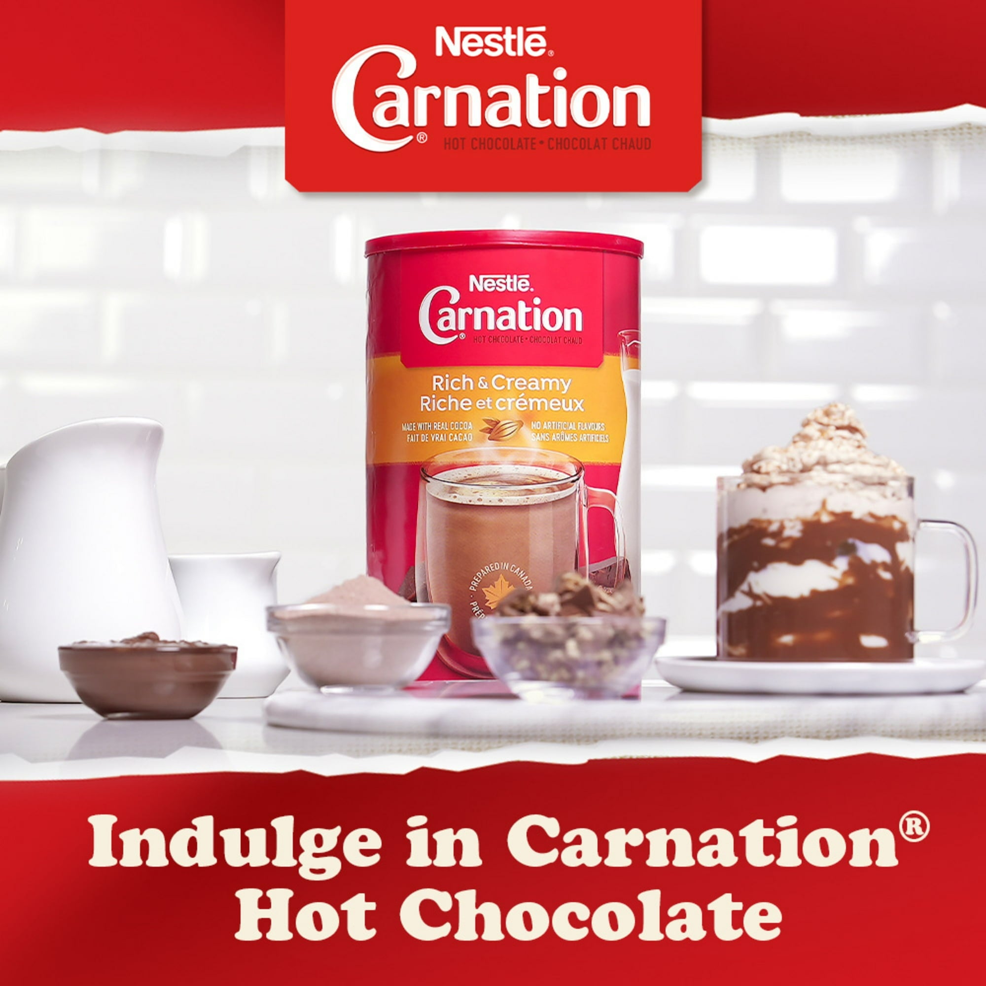 Nestle Carnation hot chocolate packaging with a cup of hot chocolate and ingredients on a white background.
