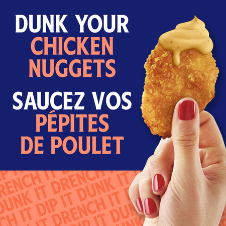 Hand holding a chicken nugget with mustard against a blue background, featuring text about dunking chicken nuggets.