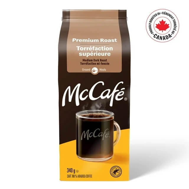 McCafe Premium Roast Medium Dark Roast Ground Coffee 1.36kg package with a cup of coffee on a white background