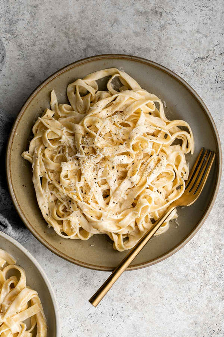 Club House Pasta Alfredo in a dish.