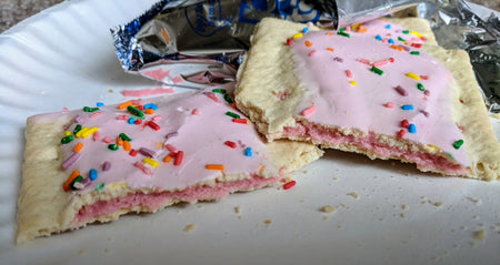 Kellogg's Pop-Tarts, Frosted Strawberry Milkshake Flavored, 8 pastries, 384g, pop tarts on a plate.