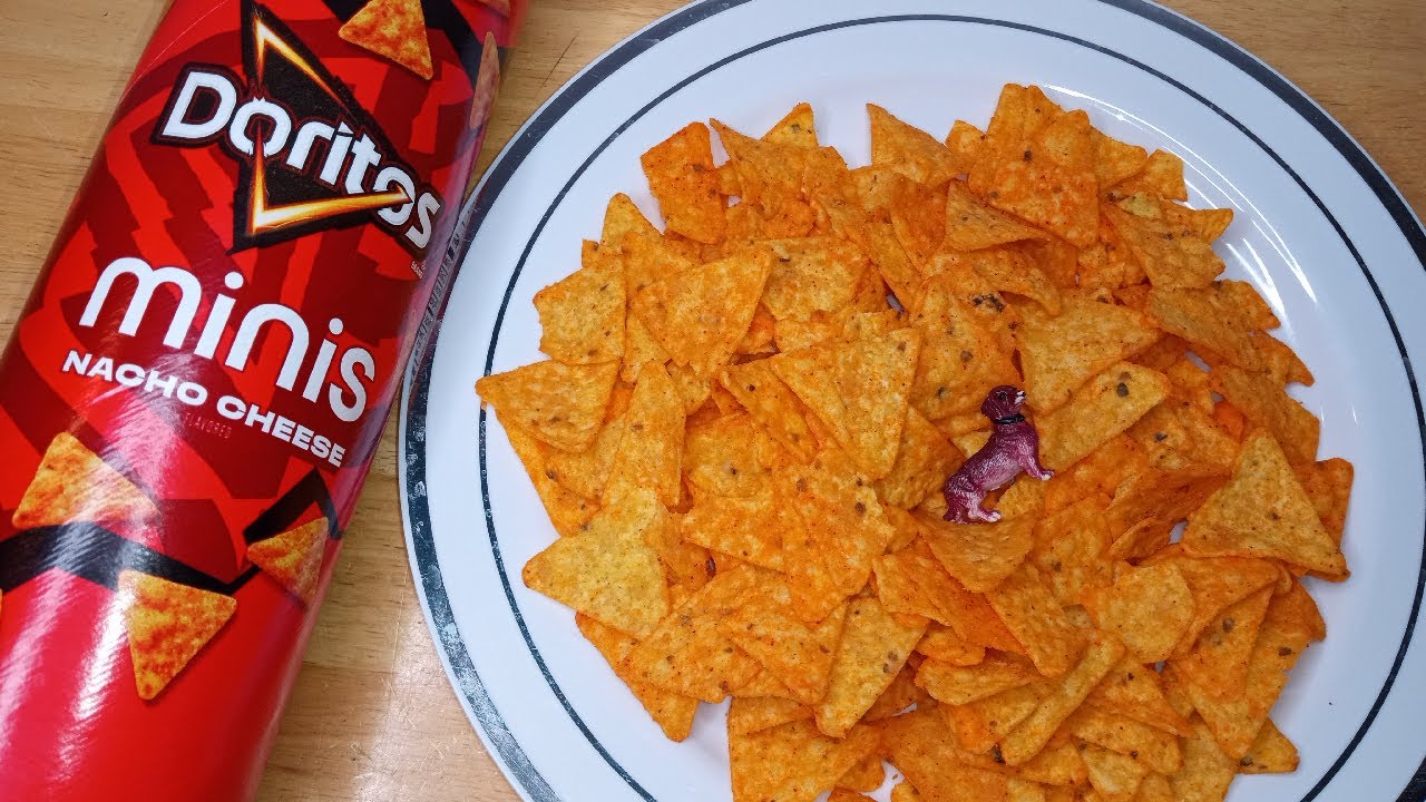 Doritos Minis Nacho Flavored Tortilla Chips, 145g, picture of minis nacho chips on a plate.